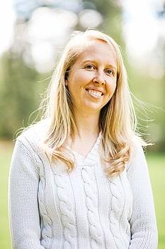 blonde woman in front of a green background